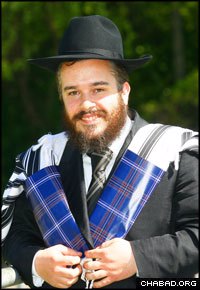 Scottish-born Rabbi Mendel Jacobs, director of The Shul in the Park in Giffnock, models the new Jewish tartan, here used to keep a tallit bundled together.