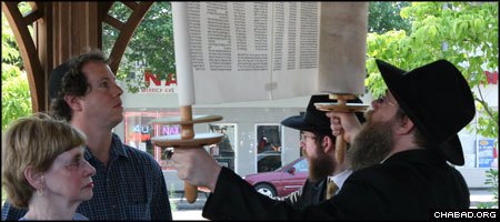 A dedication ceremony at a gazebo outside the Merrick, N.Y., train station welcomed the Chabad Center for Jewish Life’s first Torah scroll.
