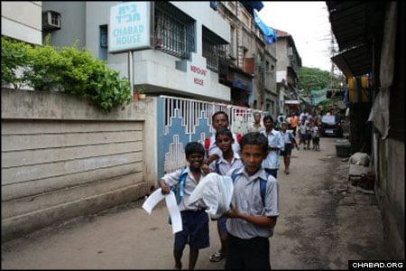 School children run outside the Chabad House in the Colaba Market area of Bombay, India. Rabbis Eli Marcus and Menachem M. Gansbourg arrived in the country July 16 as part of the Roving Rabbis program. All told, hundreds of rabbinical students are visiting Jewish communities around the world that are not served by full-time Chabad-Lubavitch centers.