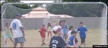Children with Camp Gan Israel of Alpharetta, Ga., play a game of soccer at the new sports facilities at the local Chabad-Lubavitch center.