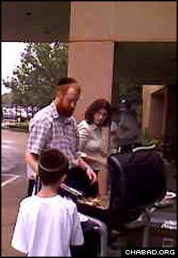 Rabbi Chaim and Chanie Lazaroff, co-directors of Chabad-Lubavitch of Uptown, hold an impromptu barbeque for the residents of the B’nai B’rith Goldberg Towers senior citizens home after Hurricane Ike knocked out power in Houston.