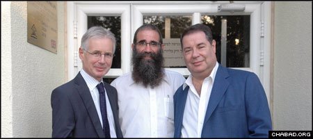 British Ambassador Tom Phillips, left, cut the ribbon to the new recreation center at the Ohr Simcha educational complex in Kfar Chabad, Israel, with Rabbi Zeev Slavin and philanthropist Michael Gross. (Photo: Berele Sheiner)
