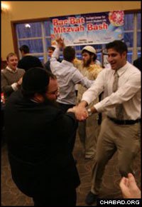 Binghamton University graduate Avi Aarons dances with Rabbi Levi Slonim during a grand bar and bat mitzvah celebration at the Chabad Center for Jewish Student Life. (Photo: Edward Lin/Chabad of Binghamton)