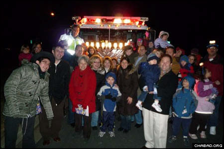 Hundreds of people gathered at each of the three stops on the parade route, taking the opportunity to pose in front of the menorah-covered Rescue Engine No. 3.