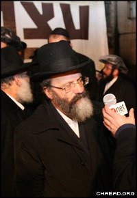 Rabbi Nachman Holtzberg, father of slain Chabad-Lubavitch emissary Rabbi Gavriel Holtzberg, speaks to a reporter at memorial ceremony in Jerusalem for his son, daughter-in-law and four other victims. (Photo: Pini Rosen)