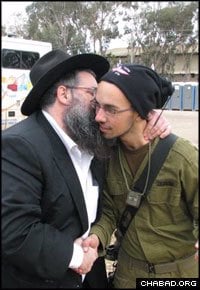 Chabad-Lubavitch Rabbi Moshe Ze&#39;ev Pizem blesses an Israeli soldier prior to his deployment to the Gaza Strip.
