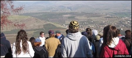 Jewish young adults on a free tour of the Holy Land look out over a valley from Israel’s Golan Heights.