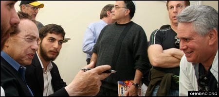 Comedian Jackie Mason banters with an attendee of a Torah class and lunch in Miami Beach, Fla.