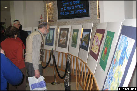 Community members peruse senior citizens’ holiday-themed artwork at the Shaarei Tsedek Charity Center in Moscow. Located next to the historic Marina Roscha synagogue, the center assists more than 15,000 people of all ages with medical services, clothing distributions, food aid and specialized activities.