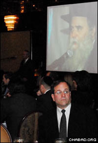 Attendees at the dinner listen to remarks by Rabbi Moshe Kotlarsky, Levi’s grandfather. (Photo: Yosef Lewis)