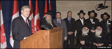 Canadian PM Stephen Harper addresses a reception for 100 Chabad-Lubavitch emissaries on Parliament Hill in Ottawa as Rabbi Moshe Kotlarsky, second from left, vice chairman of the Chabad-Lubavitch educational arm, and Immigration Minister Jason Kenney look on. (Photo: Peter Waiser)