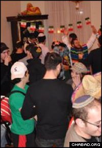 Students celebrate Purim with Rabbi Yudi and Rivky Steiner at the Lubavitch Center in Washington.