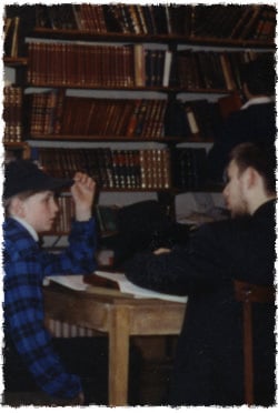 A rabbinical student learns Judaism with one of the local kids.