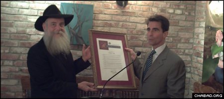 Rabbi Boruch Shlomo Cunin, left, receives a copy of a Chabad Day resolution from California state Sen. Mark Leno. (Photo: Michael Ross)