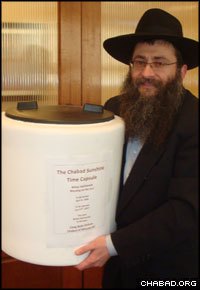 Rabbi Anchele Perl holds the Chabad Sunshine Time Capsule.