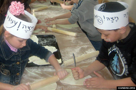 Students poke holes in their matzah dough, a necessary step to ensure proper baking.