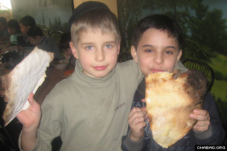 The students proudly show off their matzahs.