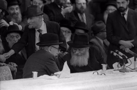 The Rebbe and Shazar converse during an interlude between the Rebbe’s scholarly addresses. &#169; 2009 JERRY DANTZIC ARCHIVES, All Rights Reserved