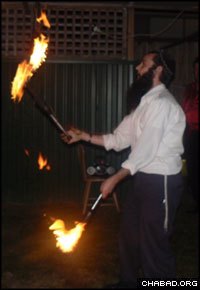A coordinator of the Chabad Teens program in the Malvern section of Melbourne juggles fire.