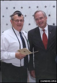 Mitch Wenzel, left, wore tefillin to a 2006 memorial ceremony for fallen CIA operatives presided over by the then-director of the agency Porter Goss.