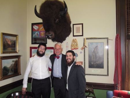 Rabbis Leibel Kahanov and Ephraim Zimmerman pose with the Lt. Governor of Montana, Mr. John Bohlinger
