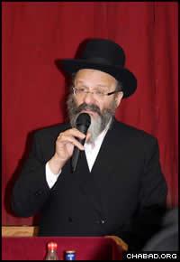 Rabbi Nachman Holtzberg addresses a Chasidic gathering at Lubavitch House in Stamford Hill, London.