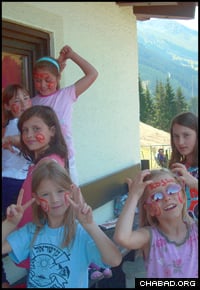 Campers enjoy a variety of activities, from face painting to mountain sliding.