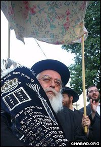 Celebrants paraded the new Torah scroll beneath the same canopy that Rabbi Aharon Mendel Hazan let Russian immigrants to Israel use for their weddings.