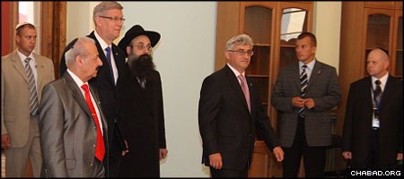 Chabad-Lubavitch Rabbi Mordechai Glazman accompanies Latvian President Valdis Zatlers, third from right, and other European officials to a dedication ceremony for the restored Peitav Synagogue in Riga.