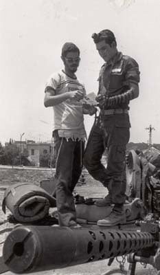 A Lubavitcher dons Tefillin with an Israeli soldier