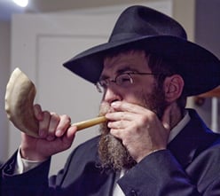 Rabbi Mendel Feldman sounds the shofar.