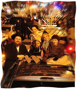 The author’s husband and children at the Menorah Parade in Philadelphia. Photo by Baruch Ezagui.