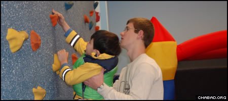 Through programs such as visits to athletic centers and one-on-one home visits, the Friendship Circle challenges children with special needs and the teenage volunteers who work with them.