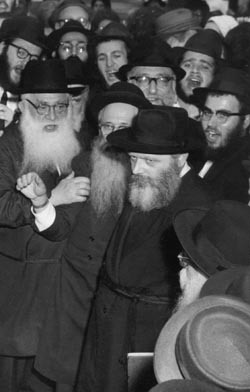 The Rebbe watching the chosson and kallah leave the chupah, following the officiating.