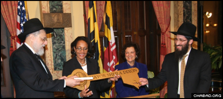 Baltimore Mayor Sheila Dixon presented the key to the city to Rabbis Shmuel Kaplan, left, director of Chabad-Lubavitch of Maryland, and Zev Gopin, director of Chabad of Johns Hopkins and Central Baltimore.