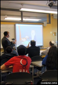 Rabbi Avraham Kivelevitz uses “Kabbala Toons” episodes to teach some 30 teenage boys and girls at SAR High School in Riverdale, N.Y.