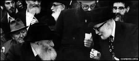 Rabbi Yosef Wineberg, right, receives a blessing from the Rebbe, Rabbi Menachem M. Schneerson, of righteous memory, who personally edited his radio lectures for 20 years.