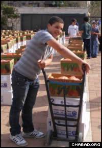 A 10th grader at the “Hartman” school readies boxes for distribution.