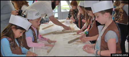 A troop of Jewish Girl Scouts take part in a model matzah bakery hosted by the Dallas Jewish Community Center and run by Chabad-Lubavitch of Dallas.