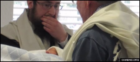 Rabbi Yossi Hecht, left, and his infant son at Ocala, Fla.’s first-recorded traditional Jewish circumcision.