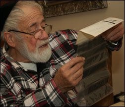 Yossi Melamed reviews one of his preserved negatives.