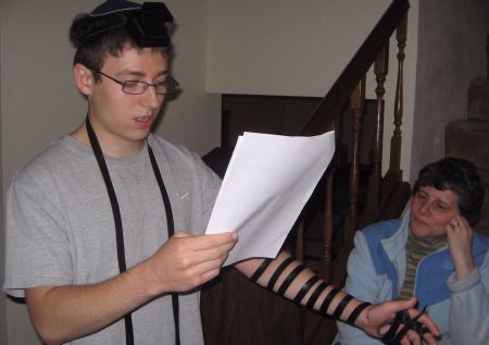 Jeff recites Shema, while wering tefillin for the first time, as his mother watches on.