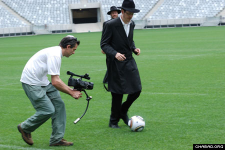 Rabbi Pini Hecht, Outreach Director of Camps Bay Shul, stays on top of the ball during a lighthearted match between a group of Chabad-Lubavitch rabbis – calling themselves Chabad United – and the Ikapa Sporting Football Club. The February face off took place in Cape Town Stadium, one of the hosting venues of the 2010 World Cup. (Photo: Leif Johannson Photography / Shawn Levin Productions)