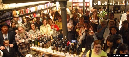 Patrons celebrate the grand opening of Call Barcelona Books and Wines, a Jewish tourist hub in the Spanish city’s historic district operated by the local Chabad-Lubavitch center.