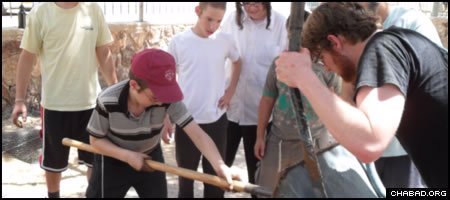 Students from the Ohr Menachem boys’ school in Arad, Israel, partner with students from the University of Vermont to build seats for the school’s basketball court from recycled materials.