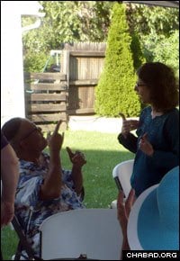 Conversing at a welcome barbeque that introduced the rabbinical students to Rochester’s deaf Jewish community.