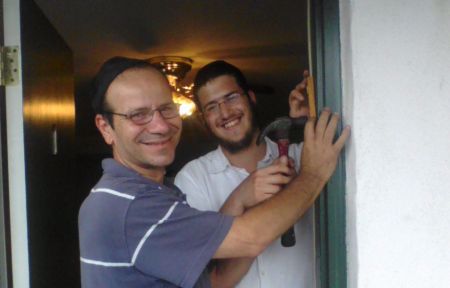 Helping someone install a new mezuzah.