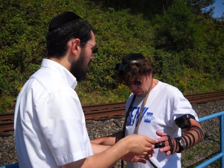 Stu laying tefillin for the first time in his life.