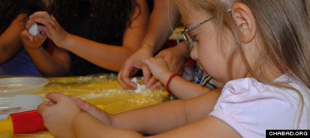 Students at the first Jewish preschool to open in Serbia in more than 50 years learn how to make challah bread.