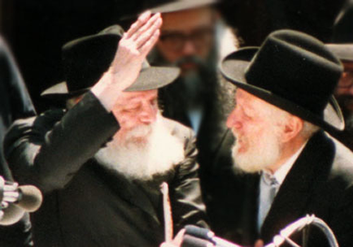 The Rebbe, of righteous memory, motions upwards with his hands to Rabbi Yaakov Yehudah (“JJ”) Hecht following a parade to bolster to Jewish unity. Rabbi Hecht had told the Rebbe that the great turnout at the parade “pulled him out” of his unfounded worries that it would not be successful; the Rebbe responded that the turnout “uplifted him.” (Photo: A. Raskin/Lubavitch Archives)